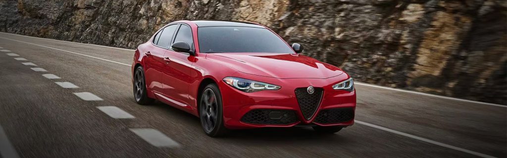 Alfa Romeo Giulia riding in a road showcasing its advanced technology and genuine performance.